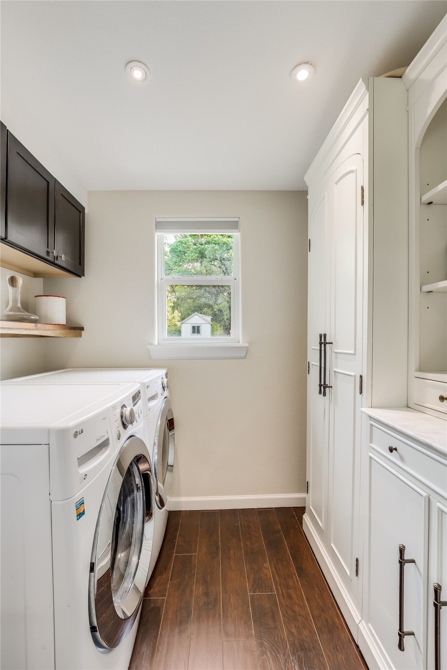 5112 Heflin Lane Austin, TX 78721 - Photo 26 of 38 The in-home laundry room comes with space for a side by side washer and dryer with cabinetry storage above.