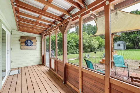 a view of a porch with wooden floor and outdoor space