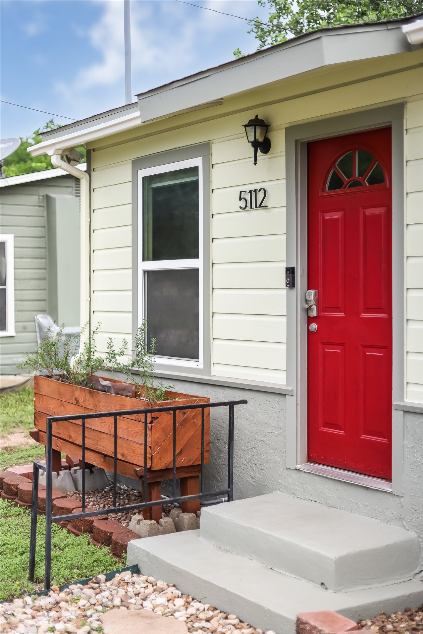 5112 Heflin Lane Austin, TX 78721 - Photo 8 of 38 A charming garden window box welcomes you home along with a vibrant red door.