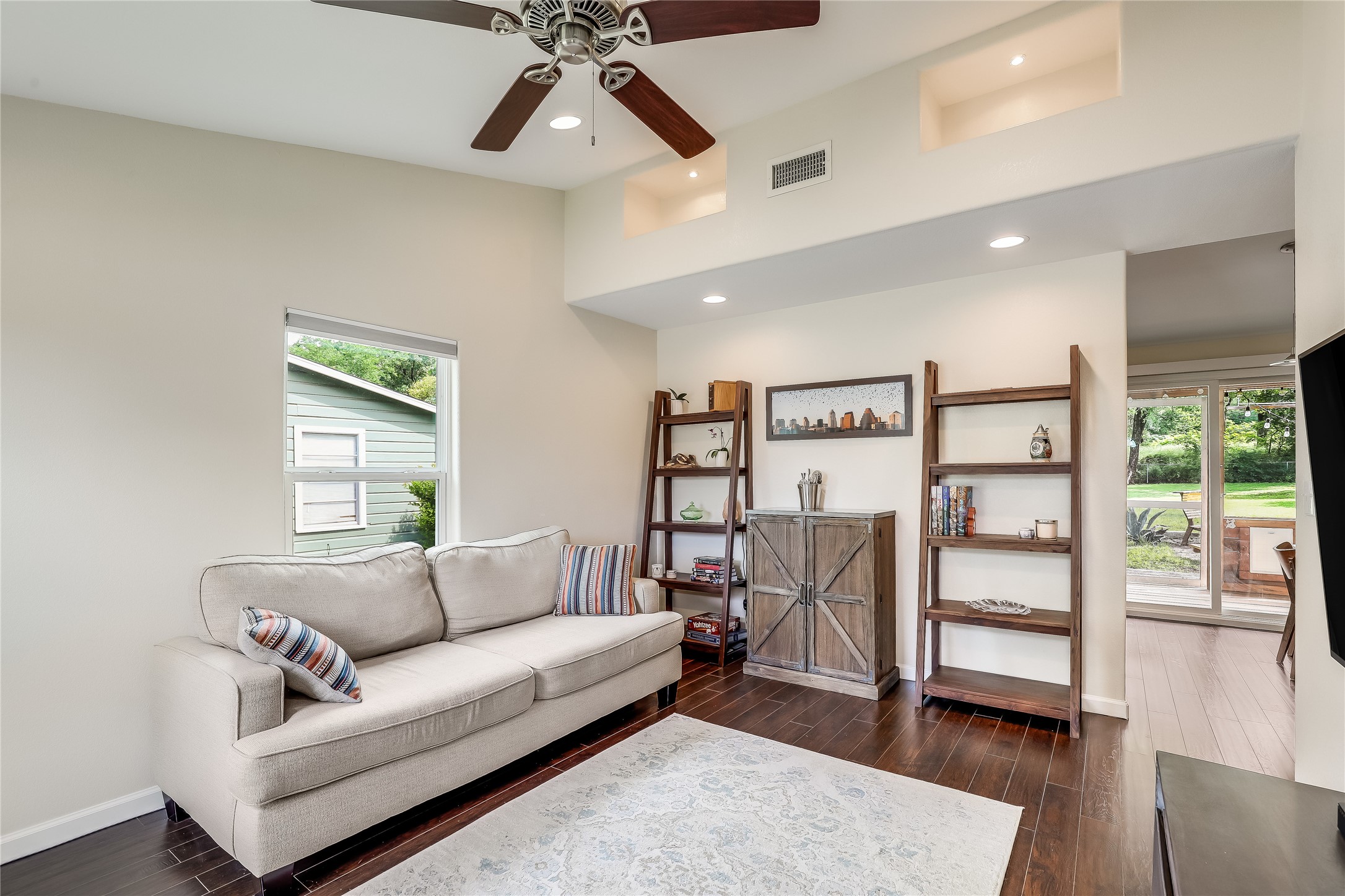 5112 Heflin Lane Austin, TX 78721 - Photo 9 of 38 The front entry opens into the bright and spacious living room under vaulted ceilings with art niches at the peak for your decor.
