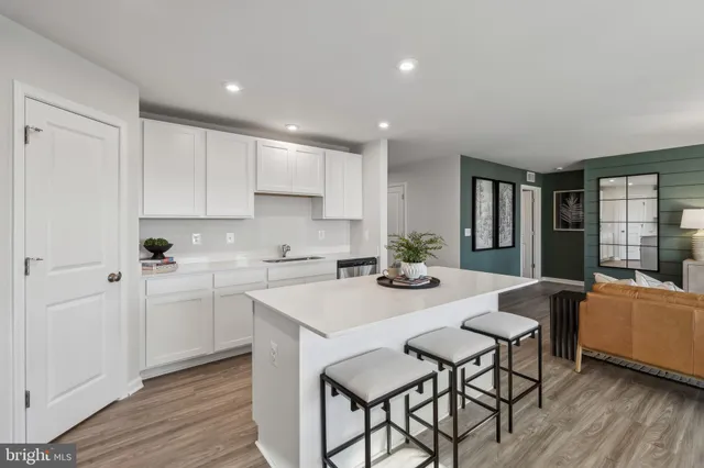 a view of kitchen with cabinets table and chairs