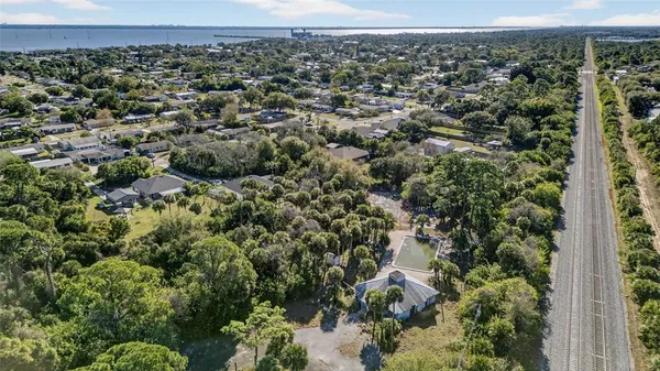 an aerial view of a house with a yard and mountain view