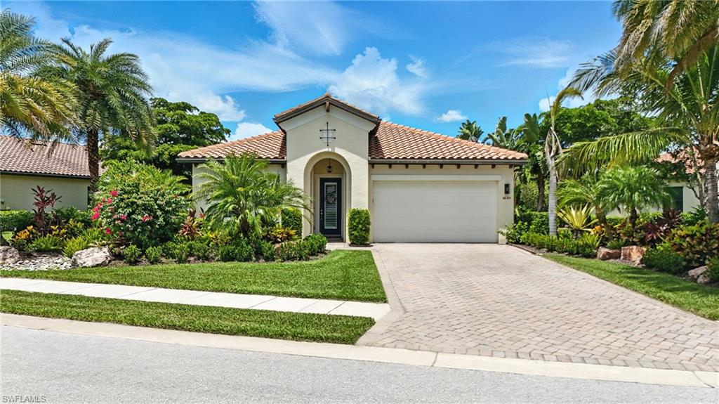 4649 Abaca Circle Naples, FL 34119 - Photo 3 of 32 a front view of a house with a garden
