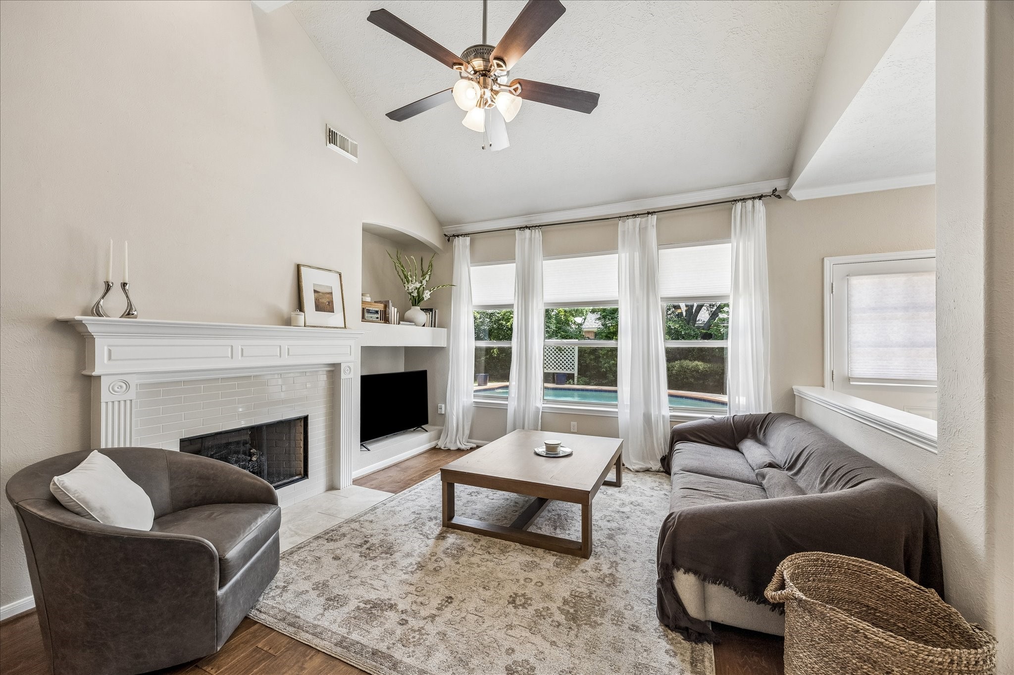 5811 Walkabout Way Katy, TX 77450 - Photo 3 of 33 Light-filled family room with soaring ceilings, a cozy fireplace, and large windows overlooking the back pool.