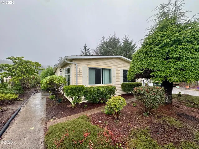 a view of a house with yard and sitting area