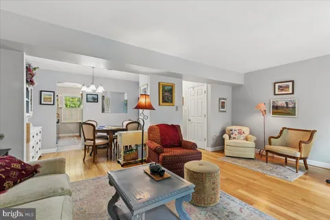 a living room with furniture a flat screen tv and kitchen view
