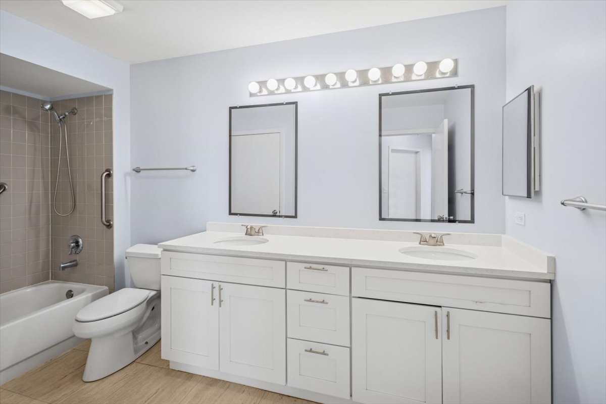 120 Cathy Lane, Unit 120 Mount Prospect, IL 60056 - Photo 16 of 20 a spacious bathroom with double sink a toilet a large mirror and shower