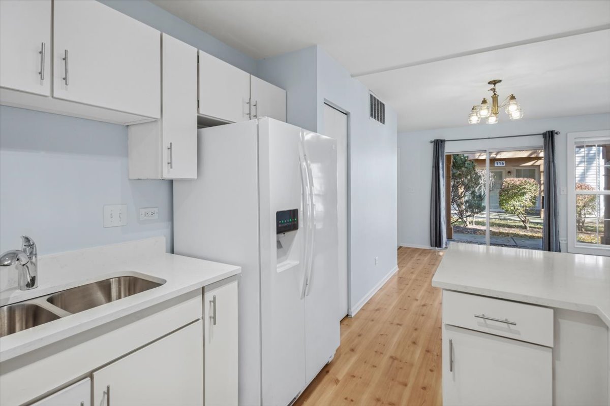 120 Cathy Lane, Unit 120 Mount Prospect, IL 60056 - Photo 9 of 20 a kitchen with a refrigerator and a sink