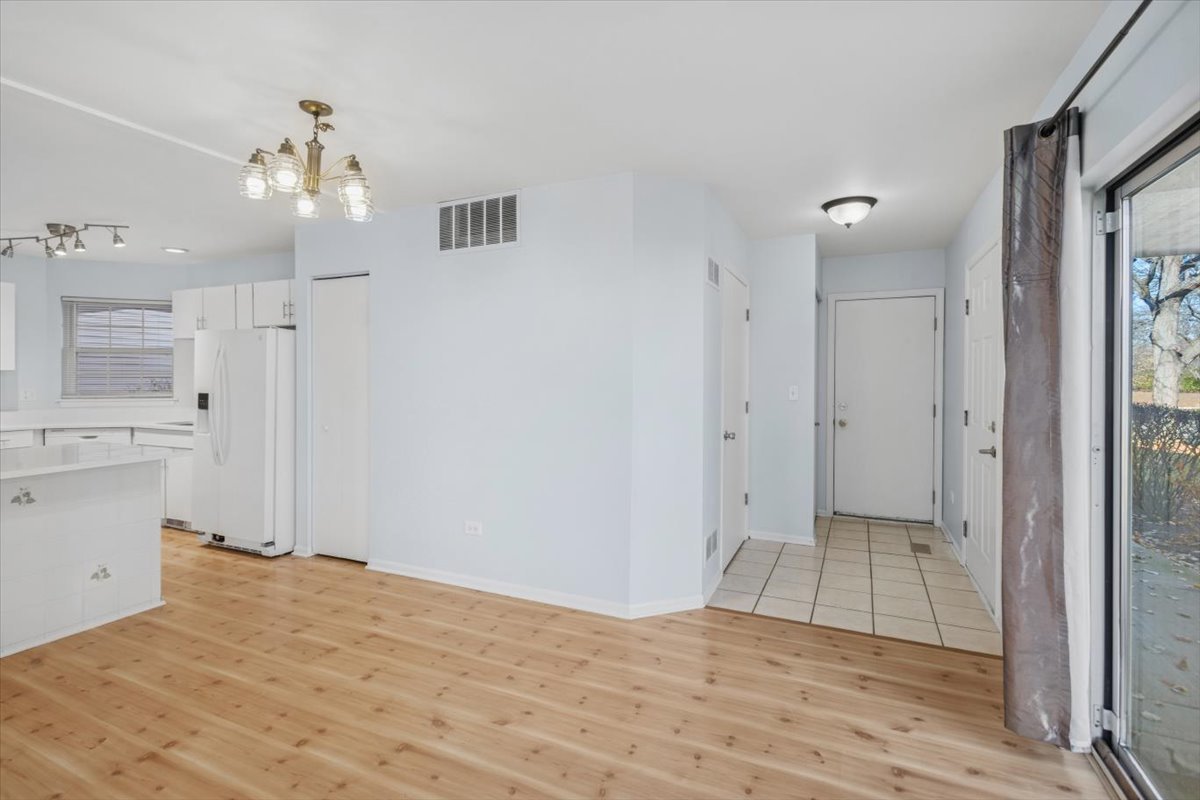 120 Cathy Lane, Unit 120 Mount Prospect, IL 60056 - Photo 10 of 20 a view of a kitchen with wooden cabinet and a bathroom