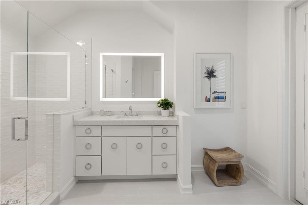 950 8th Street South Naples, FL 34102 - Photo 14 of 21 a spacious bathroom with a granite countertop sink and a mirror