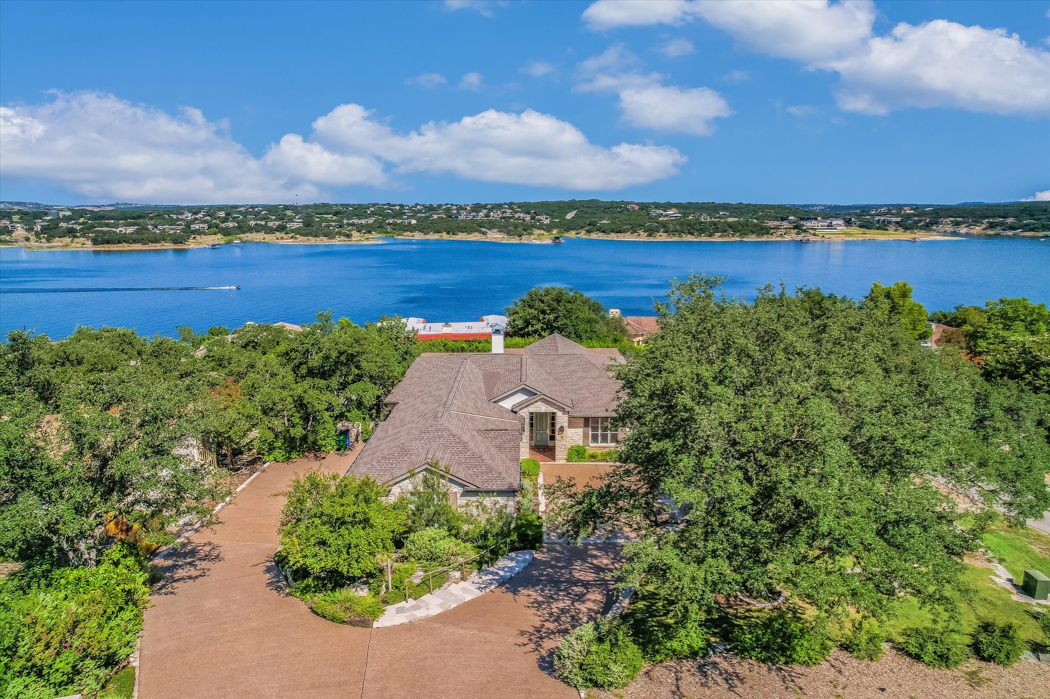 137 Firebird Lakeway, TX 78734 - Photo 1 of 1 an aerial view of a city with lots of residential buildings lake and mountain view in back