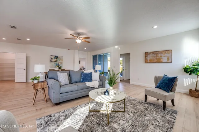 a bedroom with a bed and a ceiling fan