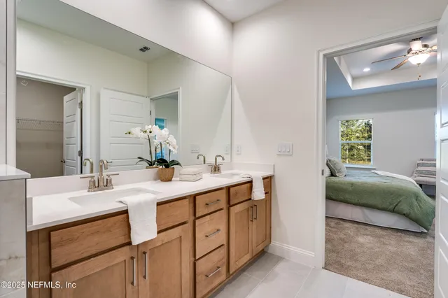 a bathroom with a double vanity sink toilet and a mirror