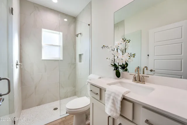 a patio with a table and chairs and potted plants