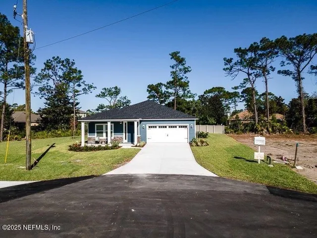 a view of pool with two chairs and a table and chair
