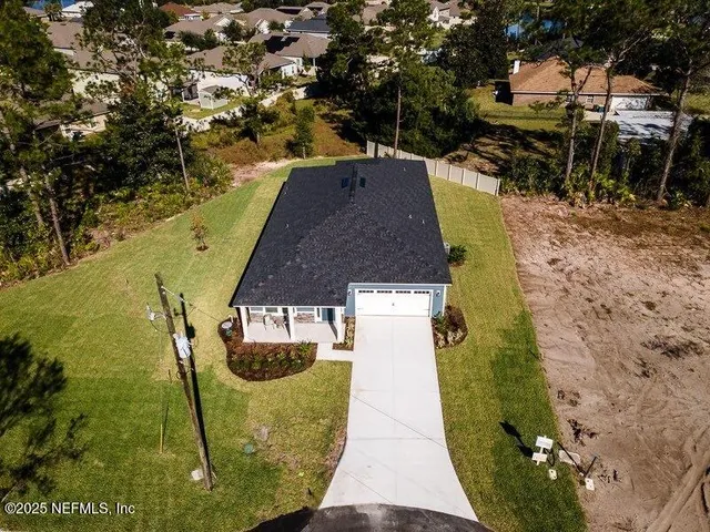 a view of a patio with a table and chairs under an umbrella