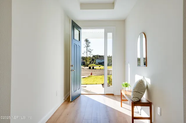 a kitchen with kitchen island white cabinets appliances and a sink