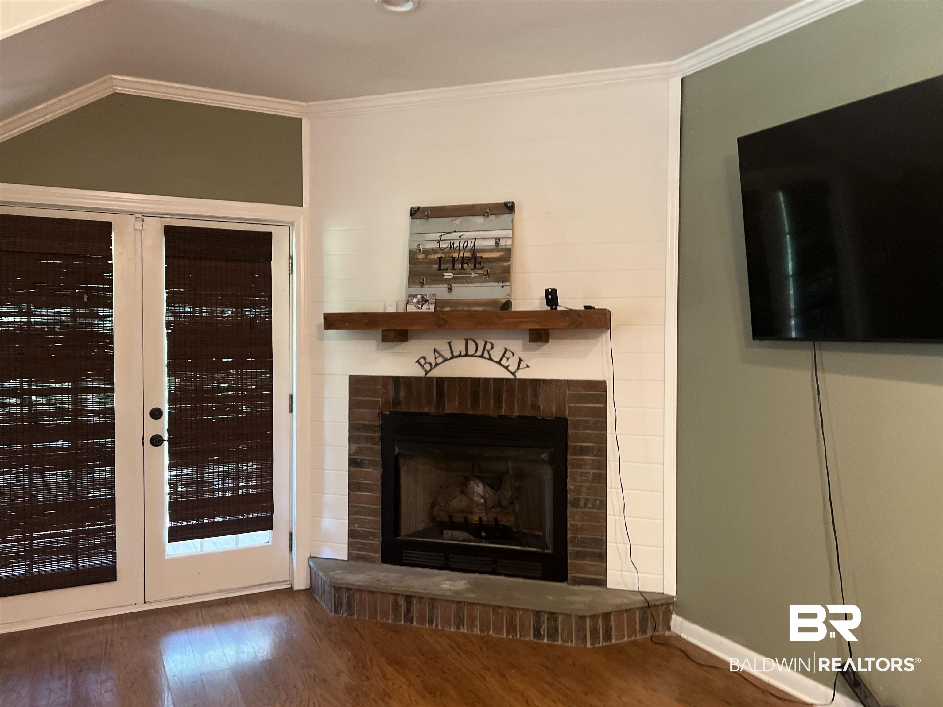 102 Brown Road Evergreen, AL 36401 - Photo 6 of 26 Unfurnished living room featuring ornamental molding, wood finished floors, a fireplace, and vaulted ceiling