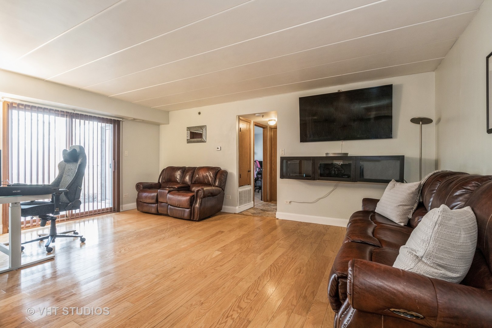 10288 SW Highway, Unit 1D Chicago Ridge, IL 60415 - Photo 3 of 12 a living room with furniture and a flat screen tv