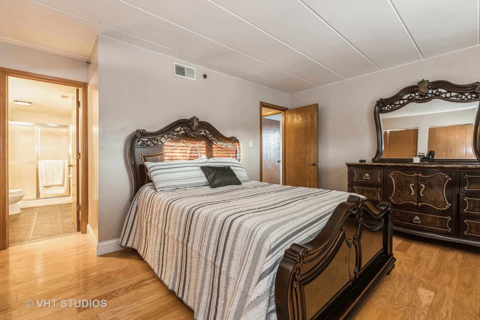 10288 SW Highway, Unit 1D Chicago Ridge, IL 60415 - Photo 7 of 12 a bedroom with a bed and wooden floor