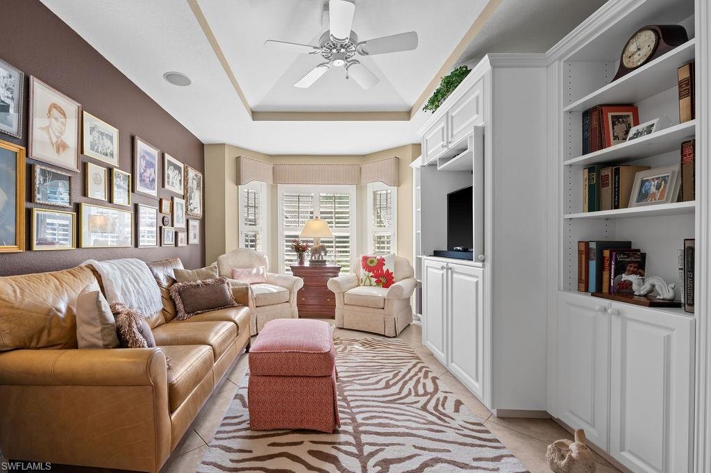 205 Via Perignon, Unit 23 Naples, FL 34119 - Photo 11 of 37 a living room with furniture or couch and a bookshelf
