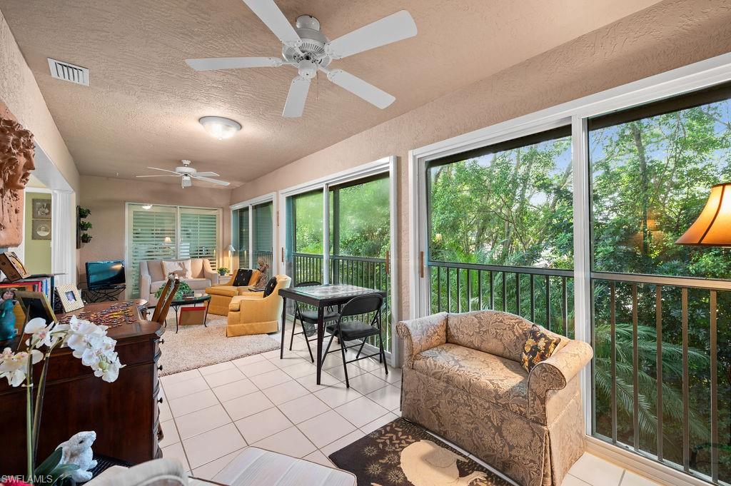 205 Via Perignon, Unit 23 Naples, FL 34119 - Photo 13 of 37 a living room with furniture and a large window