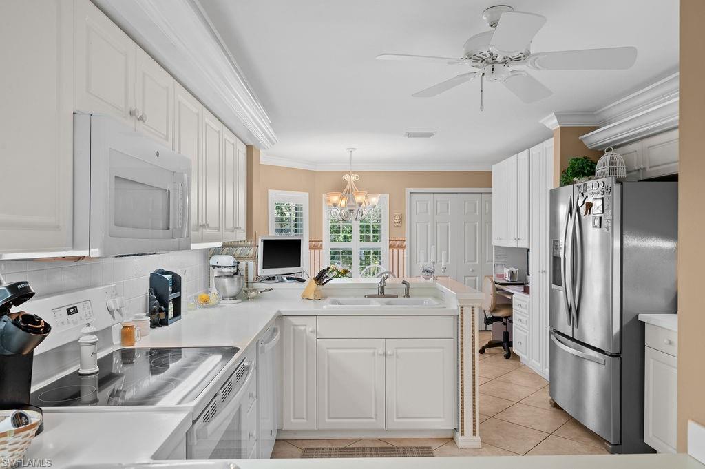 205 Via Perignon, Unit 23 Naples, FL 34119 - Photo 14 of 37 a kitchen with stainless steel appliances granite countertop a sink stove and refrigerator