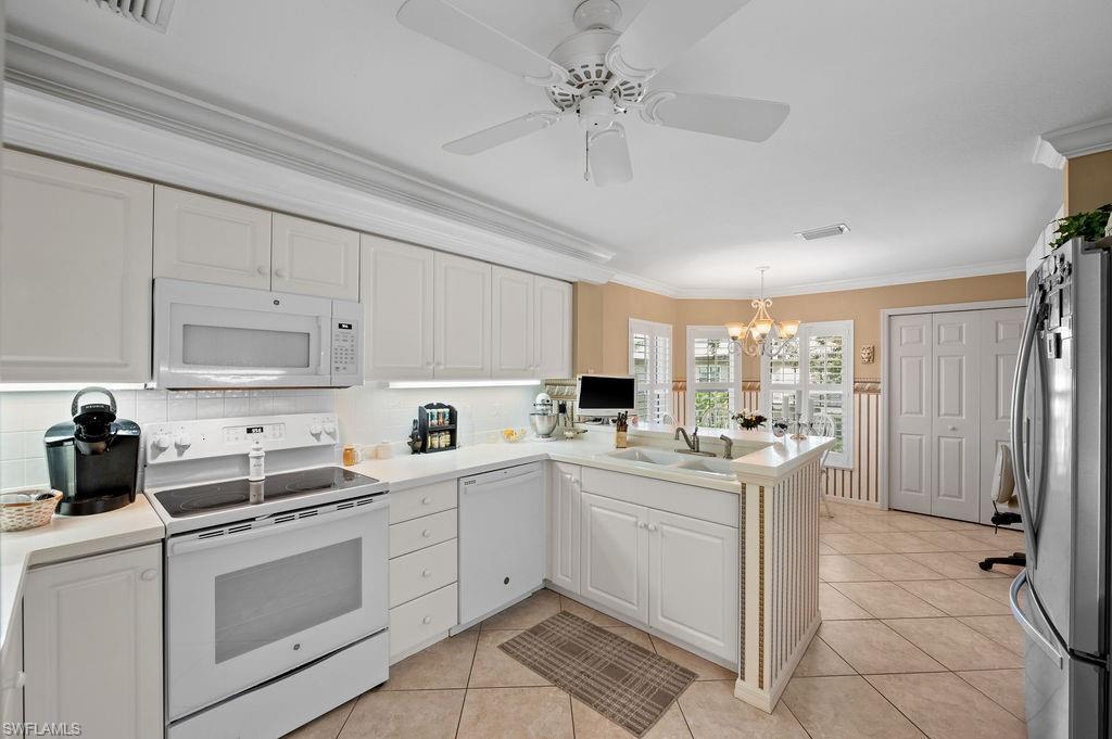 205 Via Perignon, Unit 23 Naples, FL 34119 - Photo 16 of 37 a kitchen with appliances cabinets and a sink