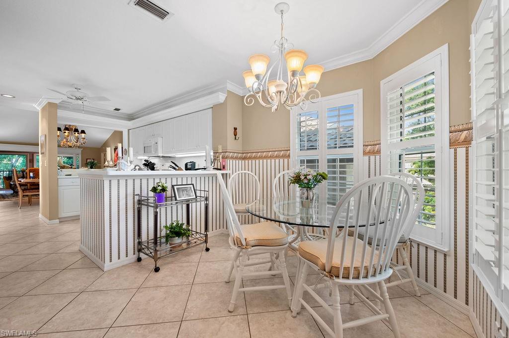 205 Via Perignon, Unit 23 Naples, FL 34119 - Photo 17 of 37 a view of a dining room with furniture and a chandelier