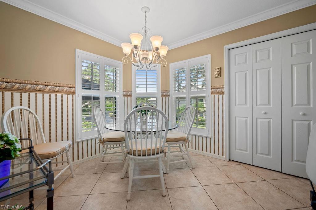205 Via Perignon, Unit 23 Naples, FL 34119 - Photo 18 of 37 a view of a dining room with furniture chandelier and wooden floor