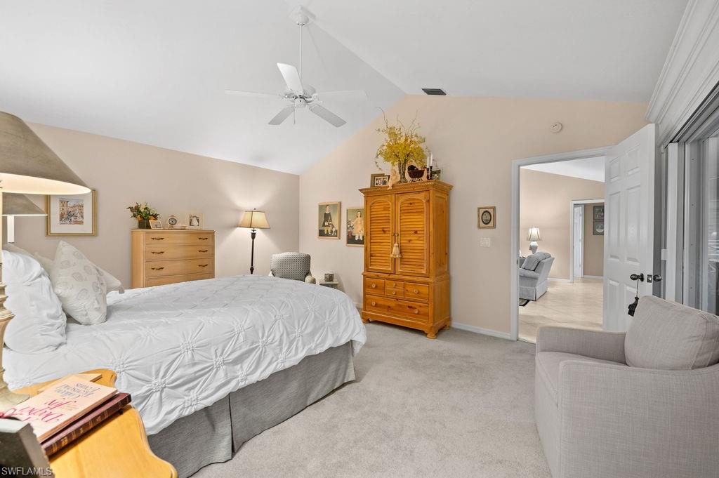 205 Via Perignon, Unit 23 Naples, FL 34119 - Photo 20 of 37 a bedroom with a bed and ceiling fan