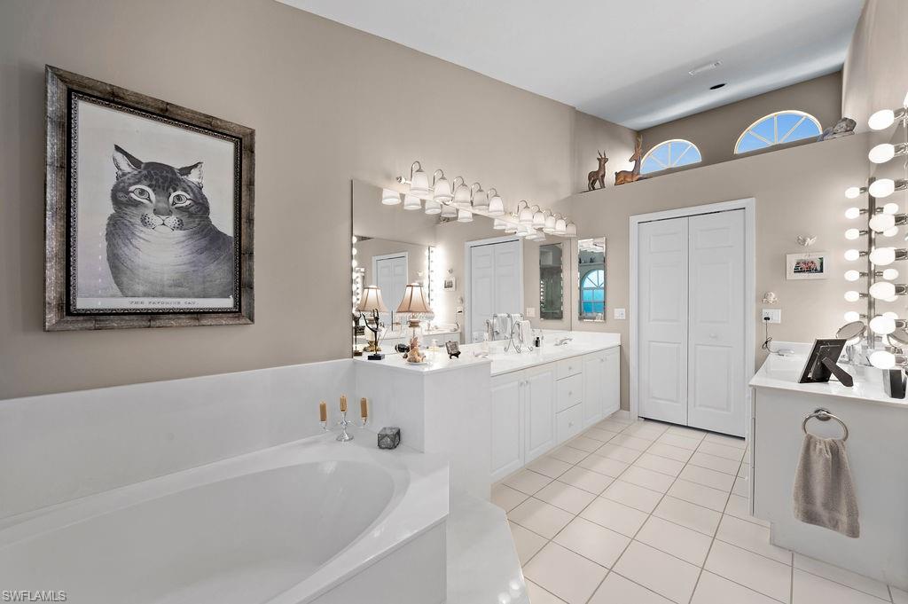 205 Via Perignon, Unit 23 Naples, FL 34119 - Photo 23 of 37 a large white tub sitting next to a bathroom sink