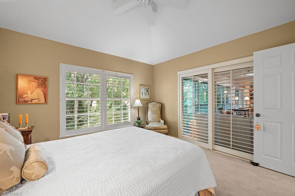 205 Via Perignon, Unit 23 Naples, FL 34119 - Photo 26 of 37 a bedroom with a bed and a large window