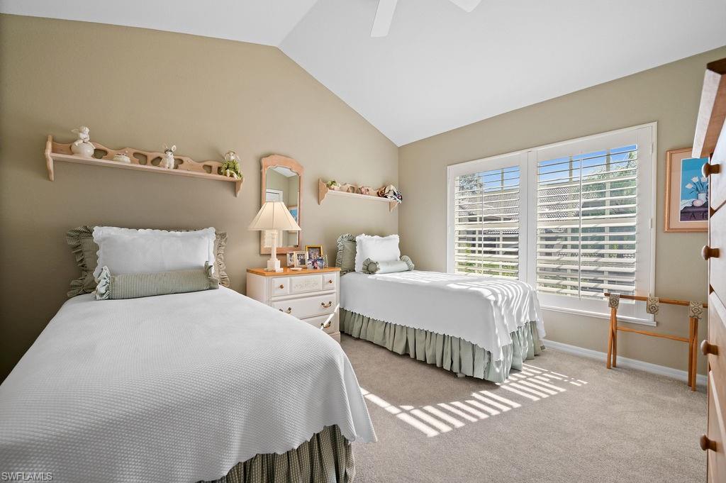 205 Via Perignon, Unit 23 Naples, FL 34119 - Photo 27 of 37 a bedroom with two beds and a window