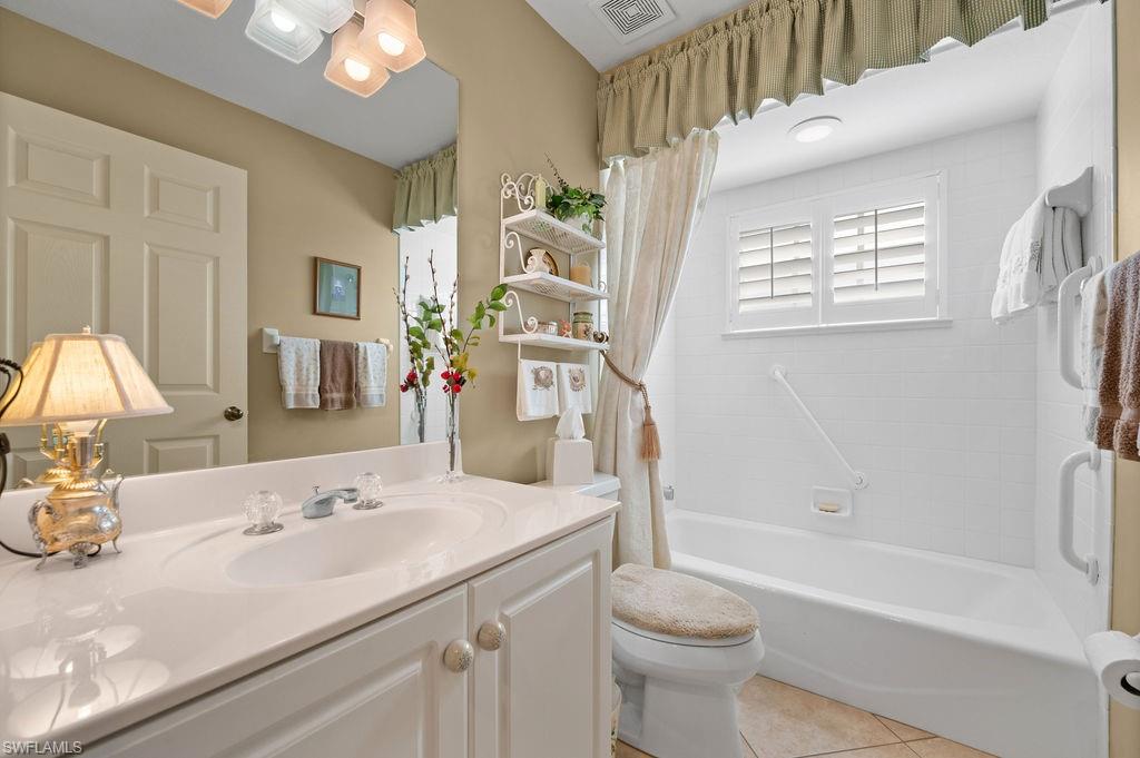 205 Via Perignon, Unit 23 Naples, FL 34119 - Photo 30 of 37 a bathroom with a sink a toilet and a bathtub