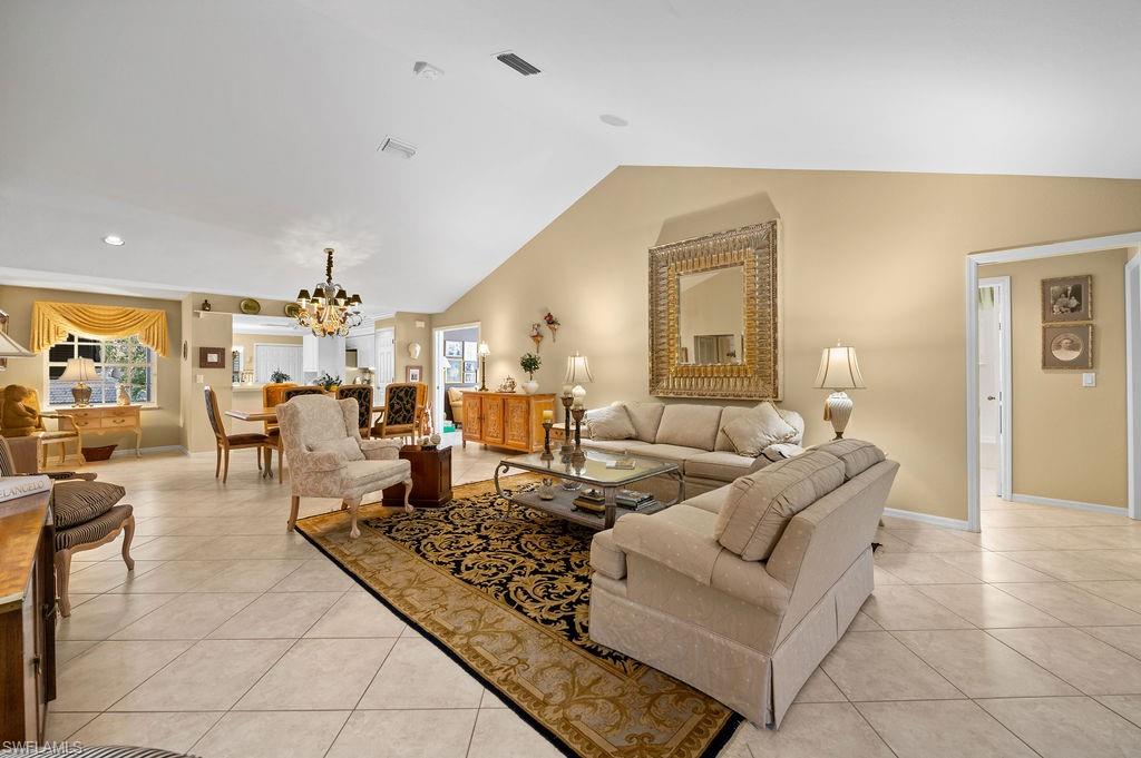 205 Via Perignon, Unit 23 Naples, FL 34119 - Photo 3 of 37 a living room with furniture and a chandelier