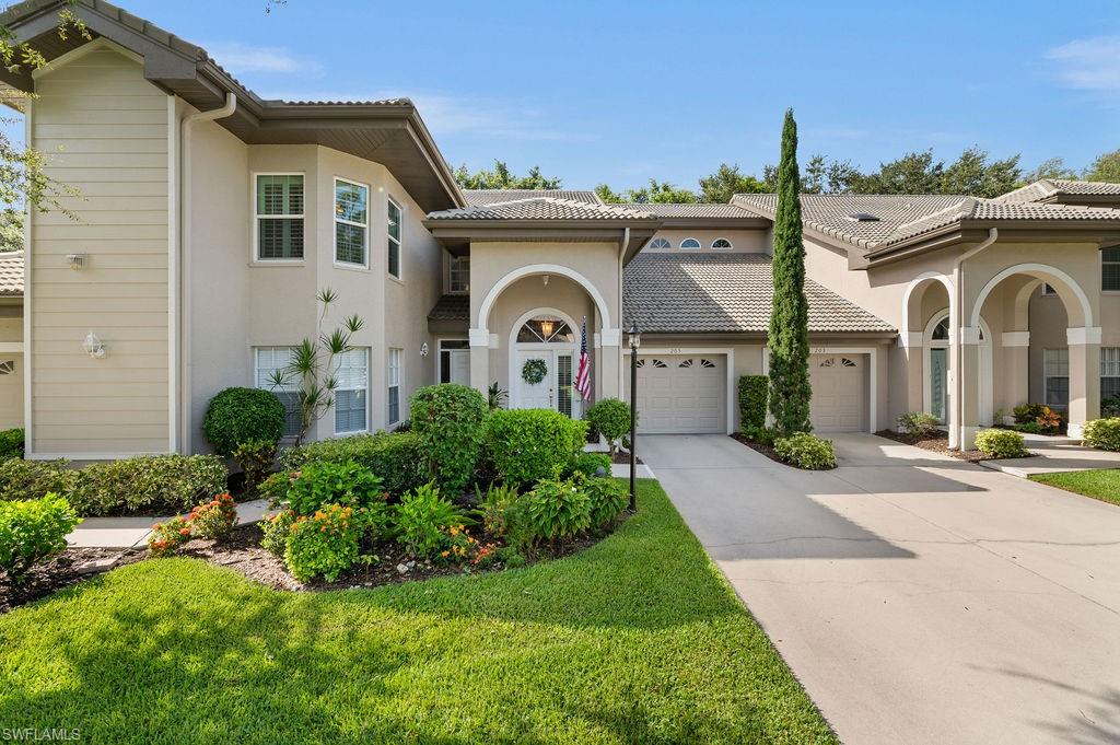 205 Via Perignon, Unit 23 Naples, FL 34119 - Photo 31 of 37 a front view of a house with garden