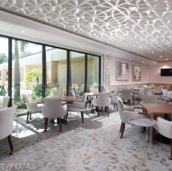 205 Via Perignon, Unit 23 Naples, FL 34119 - Photo 34 of 37 a living room with furniture and a large window