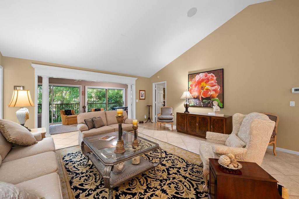 205 Via Perignon, Unit 23 Naples, FL 34119 - Photo 8 of 37 a living room with furniture and a flat screen tv