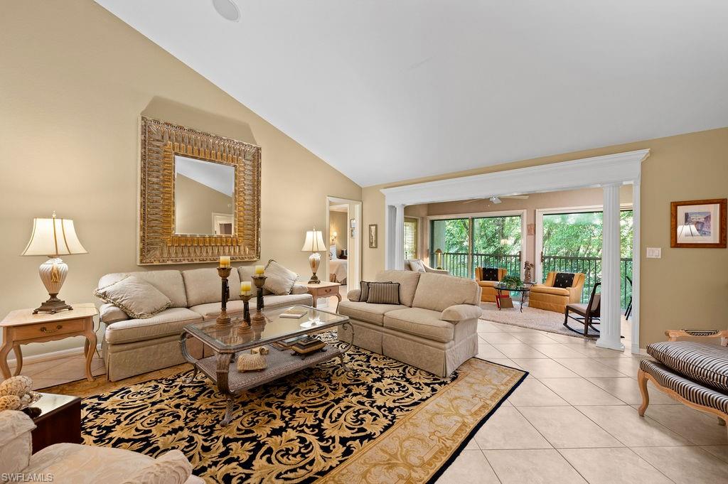 205 Via Perignon, Unit 23 Naples, FL 34119 - Photo 9 of 37 a living room with furniture and a large window