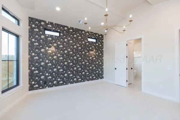 an empty room with a kitchen space and a window