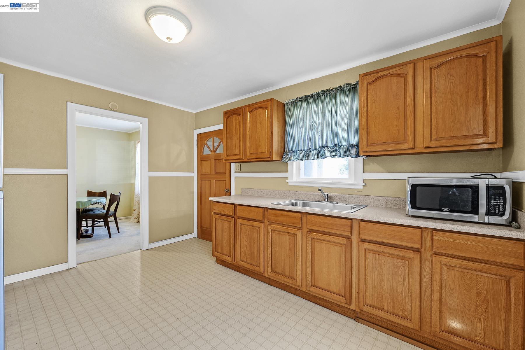 462 Hampton Road Hayward, CA 94541 - Photo 17 of 38 a kitchen with stainless steel appliances granite countertop a stove a sink and a microwave