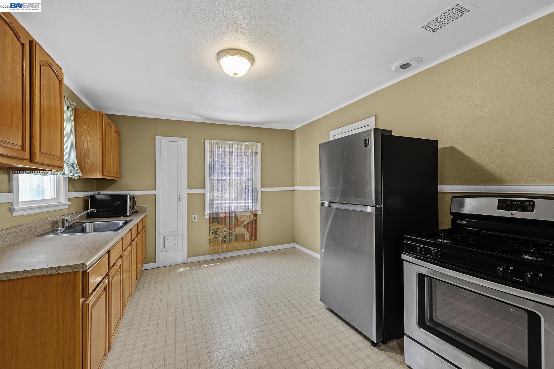 462 Hampton Road Hayward, CA 94541 - Photo 19 of 38 a kitchen with stainless steel appliances granite countertop a refrigerator stove and sink