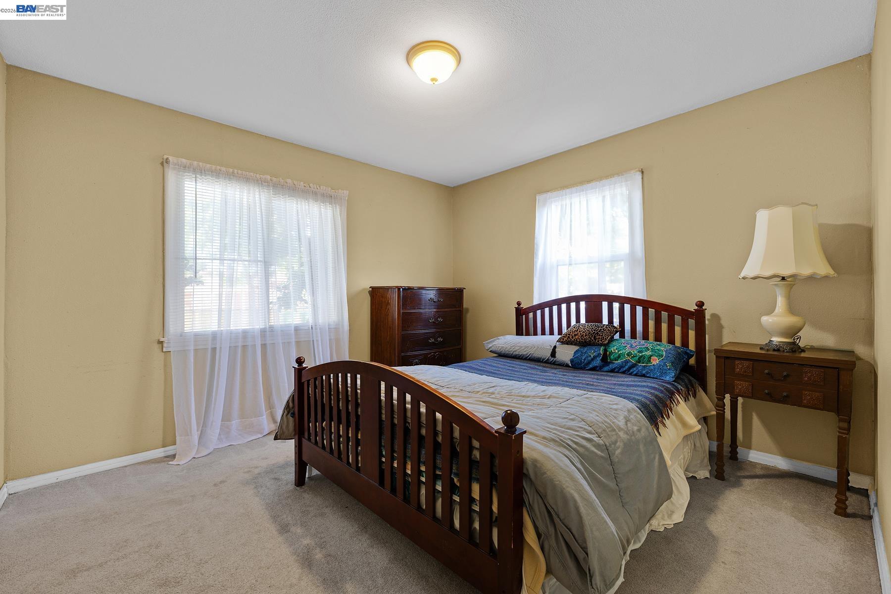 462 Hampton Road Hayward, CA 94541 - Photo 27 of 38 a bedroom with a bed and a lamp