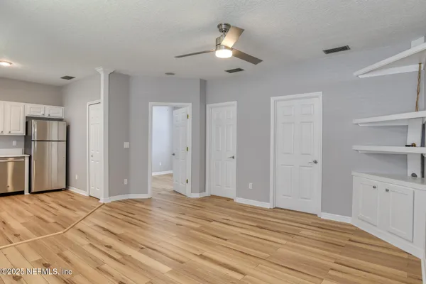 a view of a livingroom with a chandelier fan