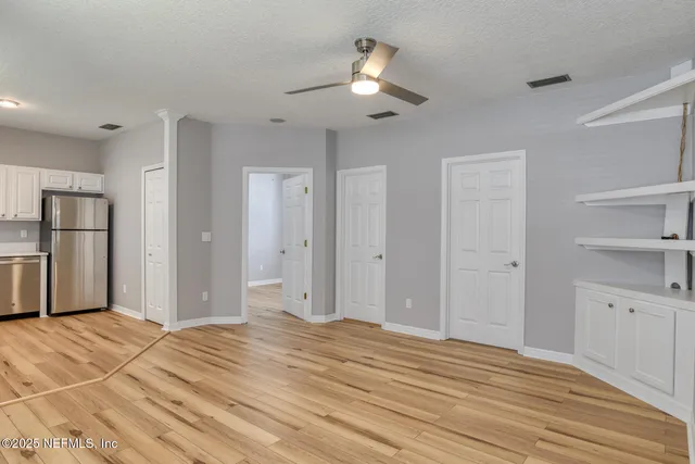 a view of a livingroom with a chandelier fan