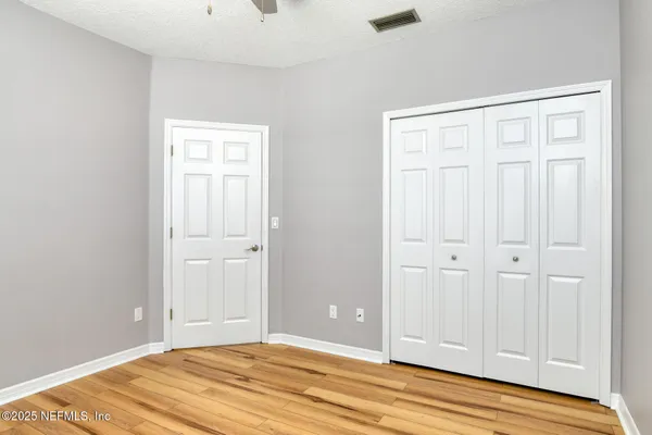 a view of a room with wooden floor