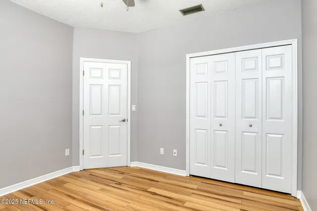 a view of a room with wooden floor
