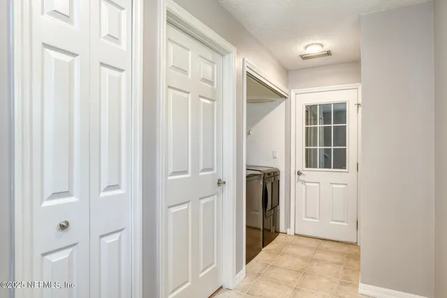 a view of a hallway with a white door