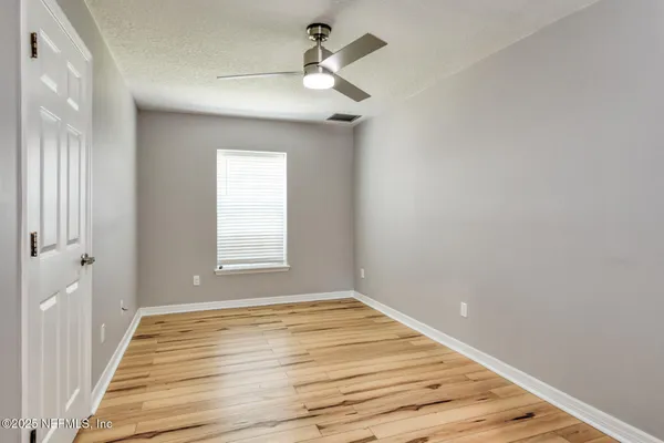 a view of wooden floor and windows in a room